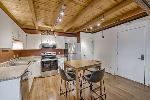 8500 Ryan Gulch Rd Unit 101, Silverthorne, CO 80498 - kitchen featuring appliances with stainless steel finishes, a sink, wood ceiling, light wood-style flooring, and rail lighting