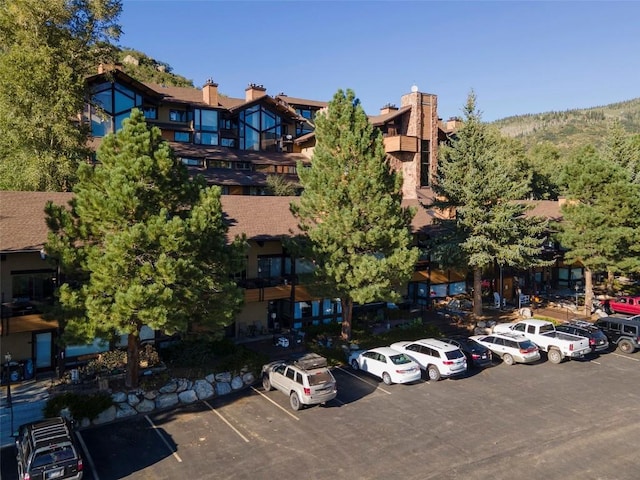 view of building exterior featuring uncovered parking