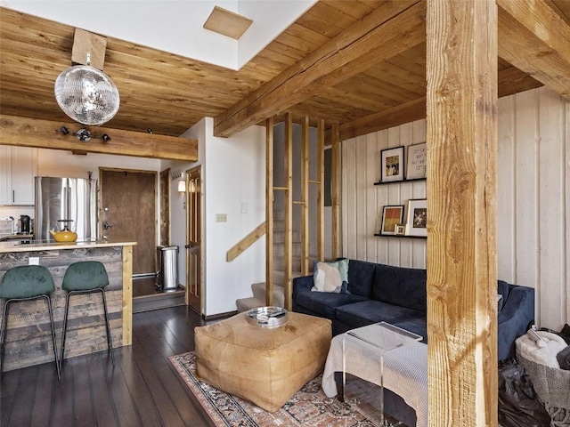 living area with wooden ceiling, stairway, dark wood finished floors, and beam ceiling