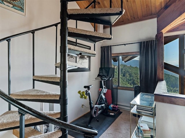 workout area featuring carpet, a baseboard heating unit, vaulted ceiling, and wooden ceiling