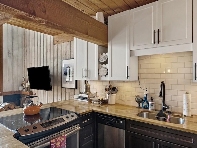 kitchen featuring stainless steel appliances, white cabinets, a sink, and decorative backsplash