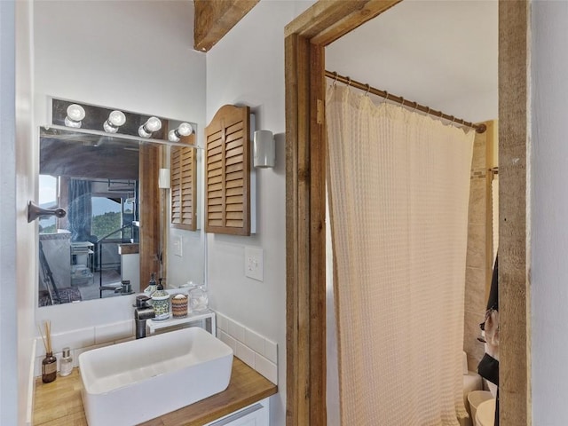 full bathroom with toilet, vanity, and a shower with shower curtain