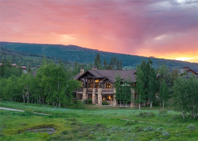 330 High Park Ct, Silverthorne, CO 80498 - back of property with a forest view, a chimney, a balcony, and stone siding