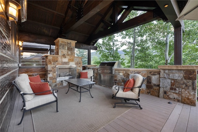 330 High Park Ct, Silverthorne, CO 80498 - deck with exterior kitchen, an outdoor stone fireplace, and area for grilling