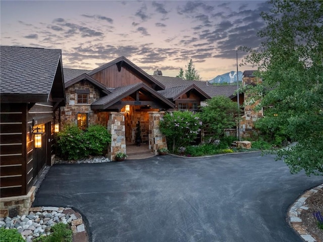 330 High Park Ct, Silverthorne, CO 80498 - view of front of property featuring roof with shingles, stone siding, and a chimney