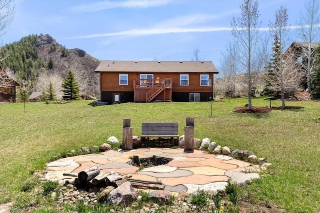 view of yard featuring a deck with mountain view and stairway