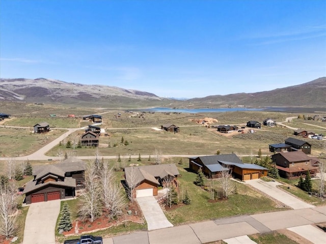 birds eye view of property featuring a water and mountain view