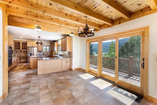 70 County Road 26, Twin Lakes, CO 81251 - kitchen featuring a chandelier, double oven, stainless steel refrigerator with ice dispenser, and baseboards