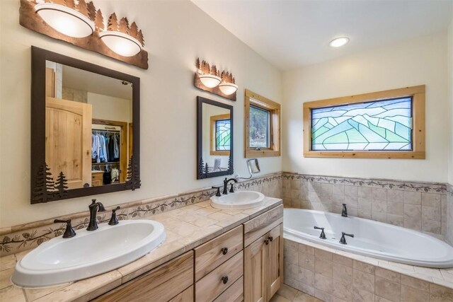 70 County Road 26, Twin Lakes, CO 81251 - bathroom with a spacious closet, double vanity, a garden tub, and a sink