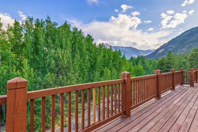 70 County Road 26, Twin Lakes, CO 81251 - wooden deck with a wooded view and a mountain view