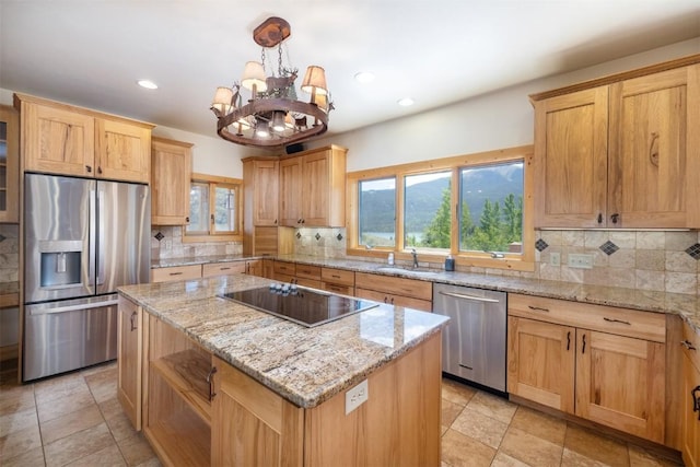70 County Road 26, Twin Lakes, CO 81251 - kitchen with a center island, a sink, decorative backsplash, an inviting chandelier, and appliances with stainless steel finishes