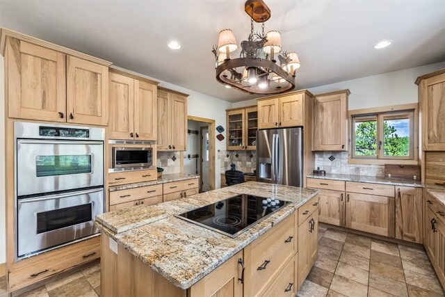 70 County Road 26, Twin Lakes, CO 81251 - kitchen featuring light brown cabinets, decorative backsplash, and stainless steel appliances