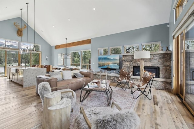 212 Cucumber Creek Rd, Breckenridge, CO 80424 - living area featuring high vaulted ceiling, light wood-style floors, plenty of natural light, and a fireplace