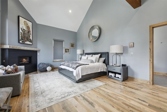 212 Cucumber Creek Rd, Breckenridge, CO 80424 - bedroom with wood finished floors, high vaulted ceiling, and a glass covered fireplace