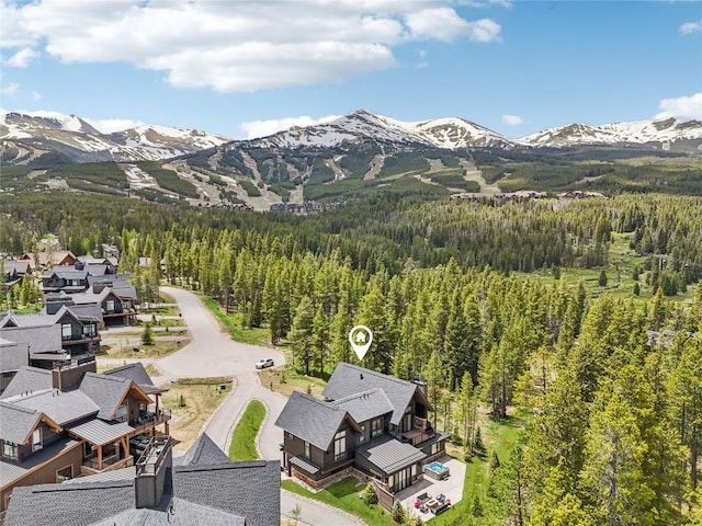 212 Cucumber Creek Rd, Breckenridge, CO 80424 - drone / aerial view of a heavily wooded area and a mountain backdrop