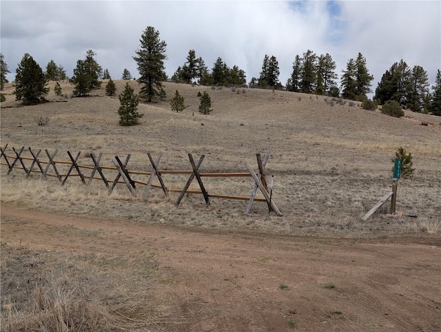 view of yard featuring a rural view and fence