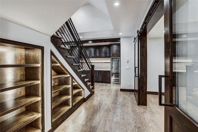 77 E Trade Ct, Keystone, CO 80435 - corridor featuring a barn door, stairs, light wood-style floors, recessed lighting, and beverage cooler