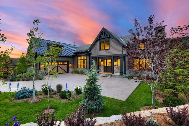 77 E Trade Ct, Keystone, CO 80435 - back of house featuring a standing seam roof, concrete driveway, a garage, and a lawn