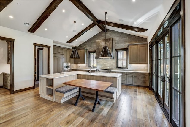 77 E Trade Ct, Keystone, CO 80435 - kitchen featuring a large island with sink, a sink, light countertops, light wood-style floors, and stainless steel appliances