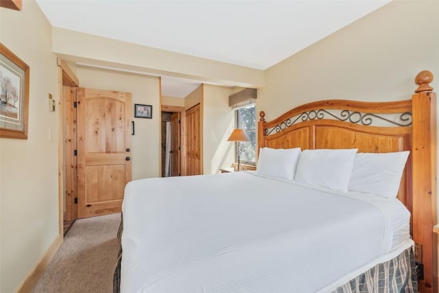 bedroom with baseboards and light colored carpet