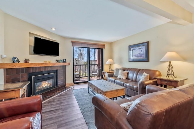 living room with a fireplace, wood finished floors, and recessed lighting