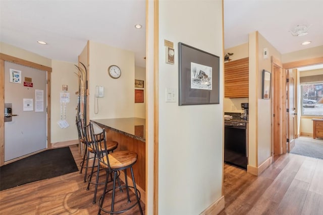 hallway featuring wood finished floors and recessed lighting