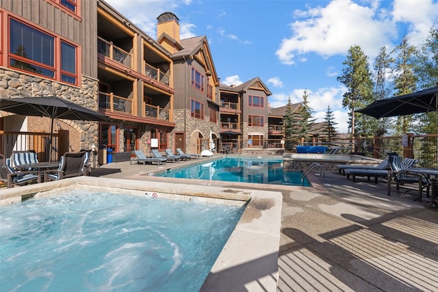 view of swimming pool with a patio area