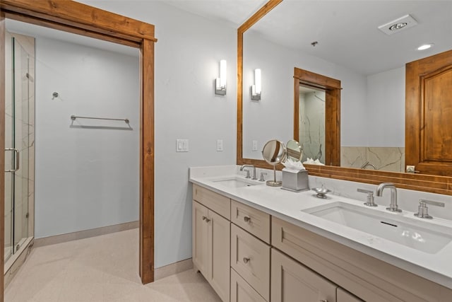 bathroom featuring vanity and a shower with shower door