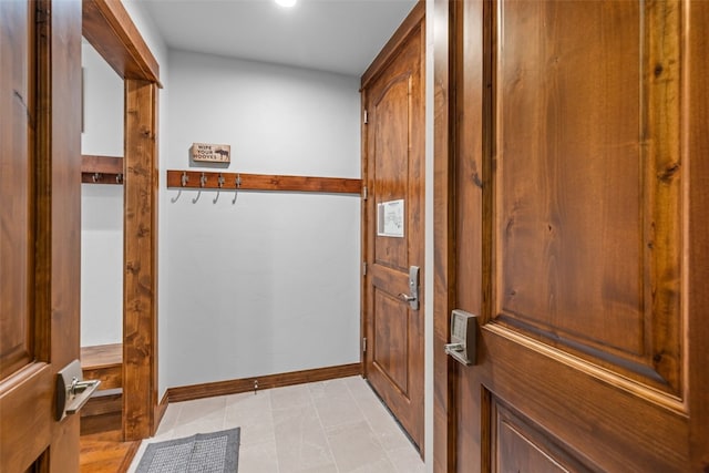 doorway to outside with light tile patterned floors