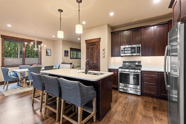 67 Outpost Dr Unit 67, Keystone, CO 80435 - kitchen featuring appliances with stainless steel finishes, dark brown cabinetry, dark wood-type flooring, and recessed lighting