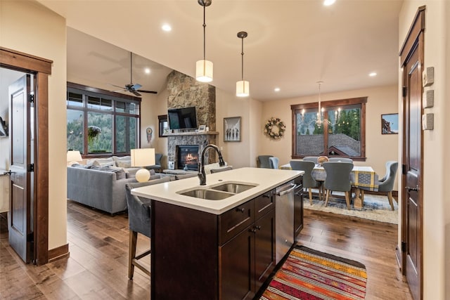 67 Outpost Dr Unit 67, Keystone, CO 80435 - kitchen featuring a stone fireplace, dark wood finished floors, light countertops, dark brown cabinets, and open floor plan