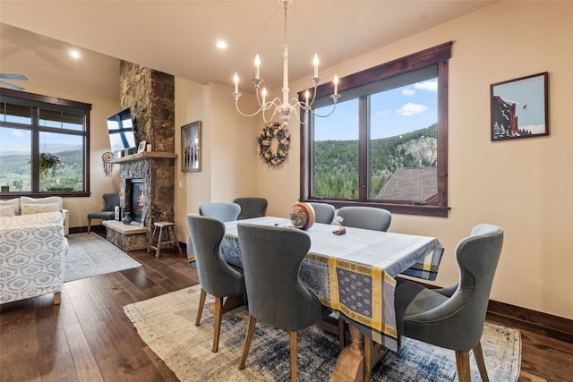 67 Outpost Dr Unit 67, Keystone, CO 80435 - dining room with a chandelier, dark wood-style flooring, a fireplace, and recessed lighting