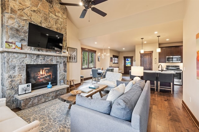 67 Outpost Dr Unit 67, Keystone, CO 80435 - living room featuring dark wood-type flooring, a ceiling fan, a stone fireplace, recessed lighting, and a chandelier