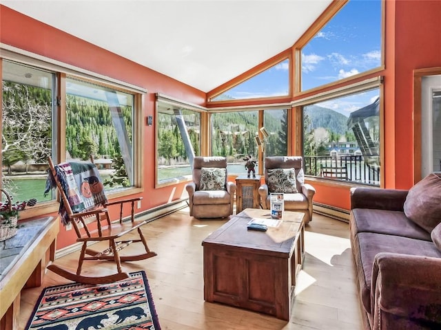 22280 US Highway 6 Unit 1717, Keystone, CO 80435 - sunroom featuring baseboard heating, a mountain view, lofted ceiling, and wood finished floors