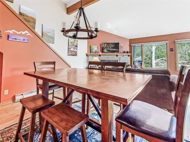 22280 US Highway 6 Unit 1717, Keystone, CO 80435 - dining room with a chandelier, wood finished floors, baseboard heating, a fireplace, and baseboards