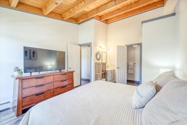 8300 Ryan Gulch Rd Unit F306, Silverthorne, CO 80498 - bedroom featuring wooden ceiling, wood finished floors, beam ceiling, a baseboard heating unit, and ensuite bath