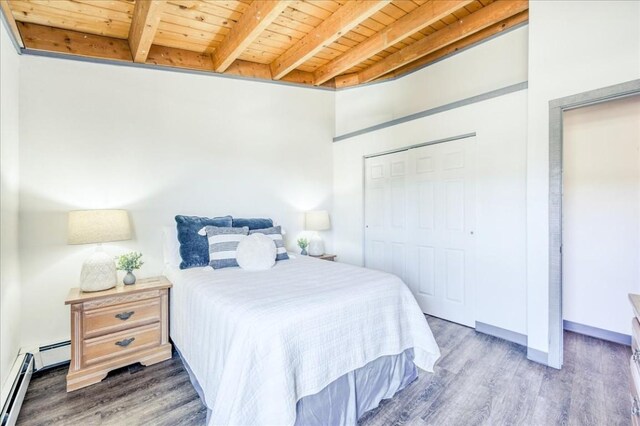 8300 Ryan Gulch Rd Unit F306, Silverthorne, CO 80498 - bedroom featuring a baseboard radiator, wooden ceiling, wood finished floors, beamed ceiling, and a closet