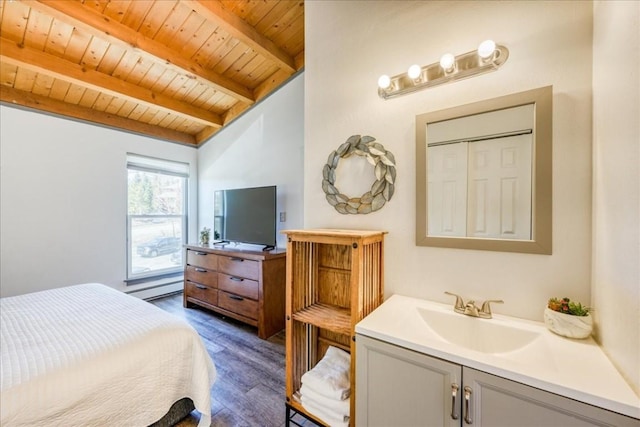 8300 Ryan Gulch Rd Unit F306, Silverthorne, CO 80498 - bedroom featuring wooden ceiling, beam ceiling, dark wood-style floors, a sink, and a baseboard radiator
