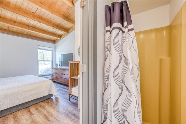 8300 Ryan Gulch Rd Unit F306, Silverthorne, CO 80498 - bedroom featuring beamed ceiling, wood finished floors, and wooden ceiling