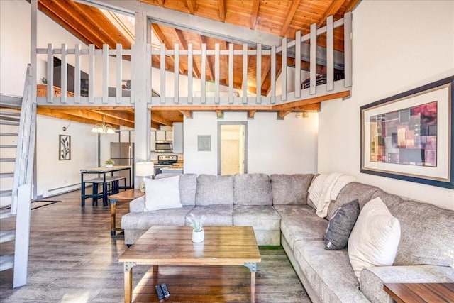 8300 Ryan Gulch Rd Unit F306, Silverthorne, CO 80498 - living area featuring wood finished floors, baseboard heating, beamed ceiling, and high vaulted ceiling