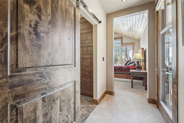 28 Tieze Ln, Keystone, CO 80435 - hall featuring a barn door, carpet flooring, and lofted ceiling