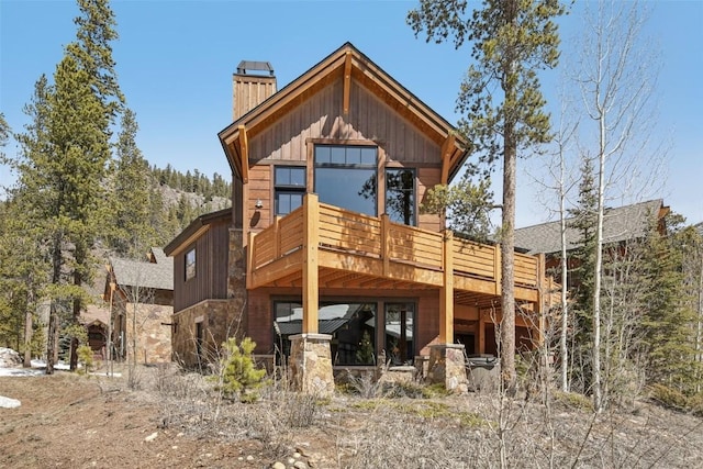 28 Tieze Ln, Keystone, CO 80435 - back of house with a chimney, stone siding, a deck, and board and batten siding