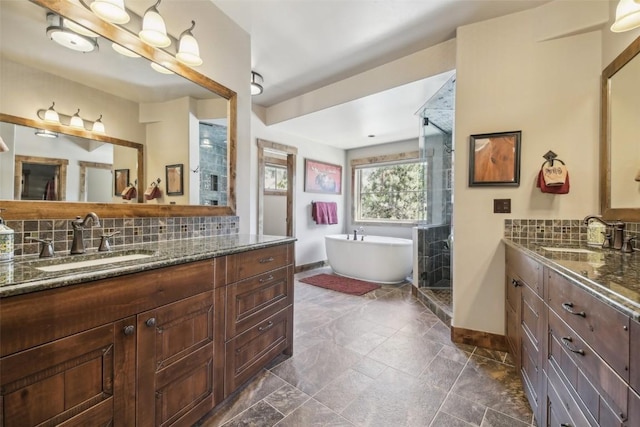 28 Tieze Ln, Keystone, CO 80435 - bathroom featuring two vanities, a shower stall, tasteful backsplash, and a soaking tub