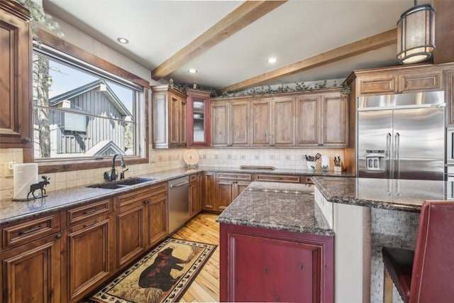 28 Tieze Ln, Keystone, CO 80435 - kitchen featuring stainless steel appliances, light wood-style floors, beamed ceiling, dark stone countertops, and backsplash