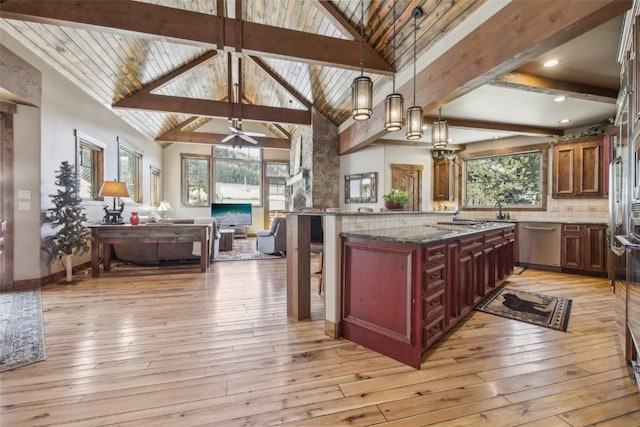 28 Tieze Ln, Keystone, CO 80435 - kitchen with open floor plan, stainless steel dishwasher, light wood-type flooring, dark stone counters, and a ceiling fan