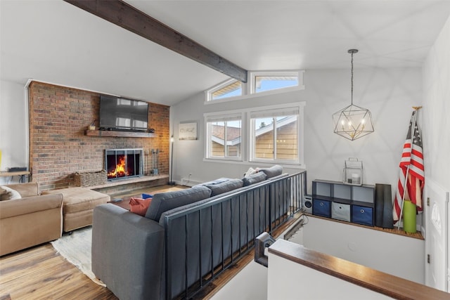 821 Pitkin St Unit 8, Frisco, CO 80443 - living area with wood finished floors, a chandelier, and a brick fireplace