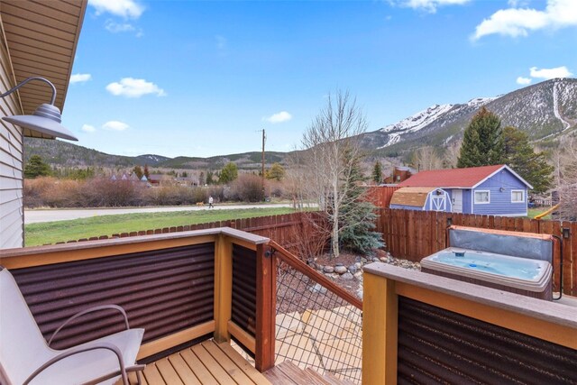 821 Pitkin St Unit 8, Frisco, CO 80443 - deck featuring a hot tub, a mountain view, and a fenced backyard