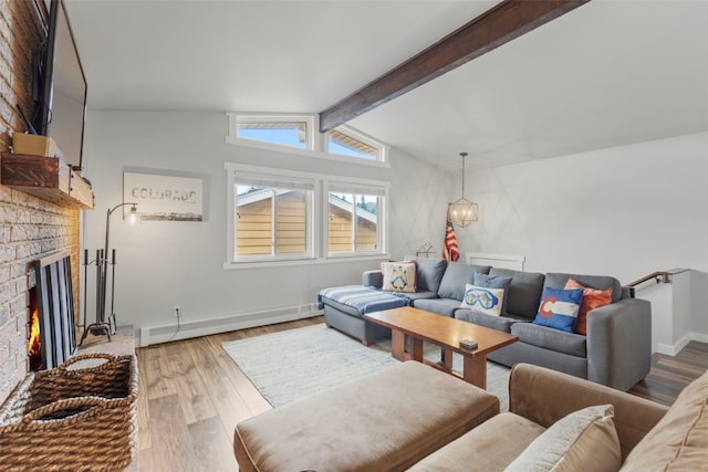 821 Pitkin St Unit 8, Frisco, CO 80443 - living room featuring wood finished floors, a fireplace, baseboard heating, baseboards, and a chandelier