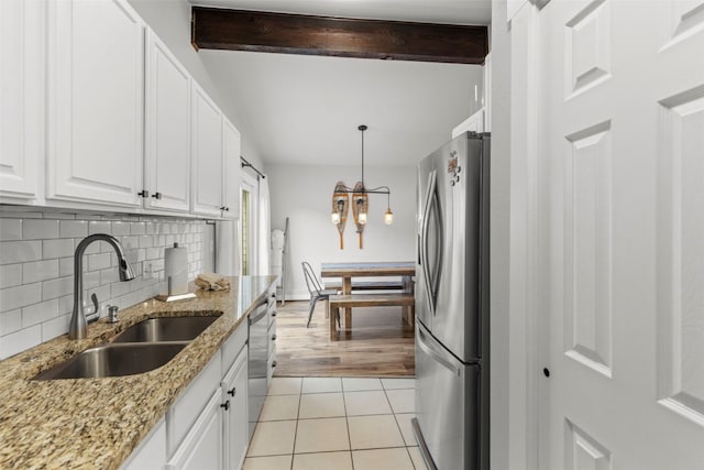 821 Pitkin St Unit 8, Frisco, CO 80443 - kitchen featuring stainless steel appliances, a sink, a chandelier, backsplash, and white cabinets