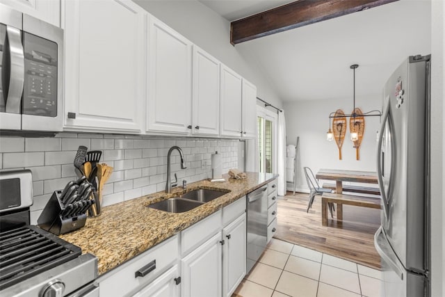 821 Pitkin St Unit 8, Frisco, CO 80443 - kitchen featuring appliances with stainless steel finishes, a sink, a chandelier, light tile patterned flooring, and tasteful backsplash